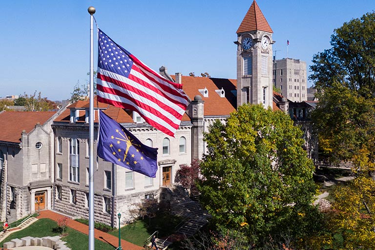 A drone view of the American and Indiana flags on display in front of the Student Building.