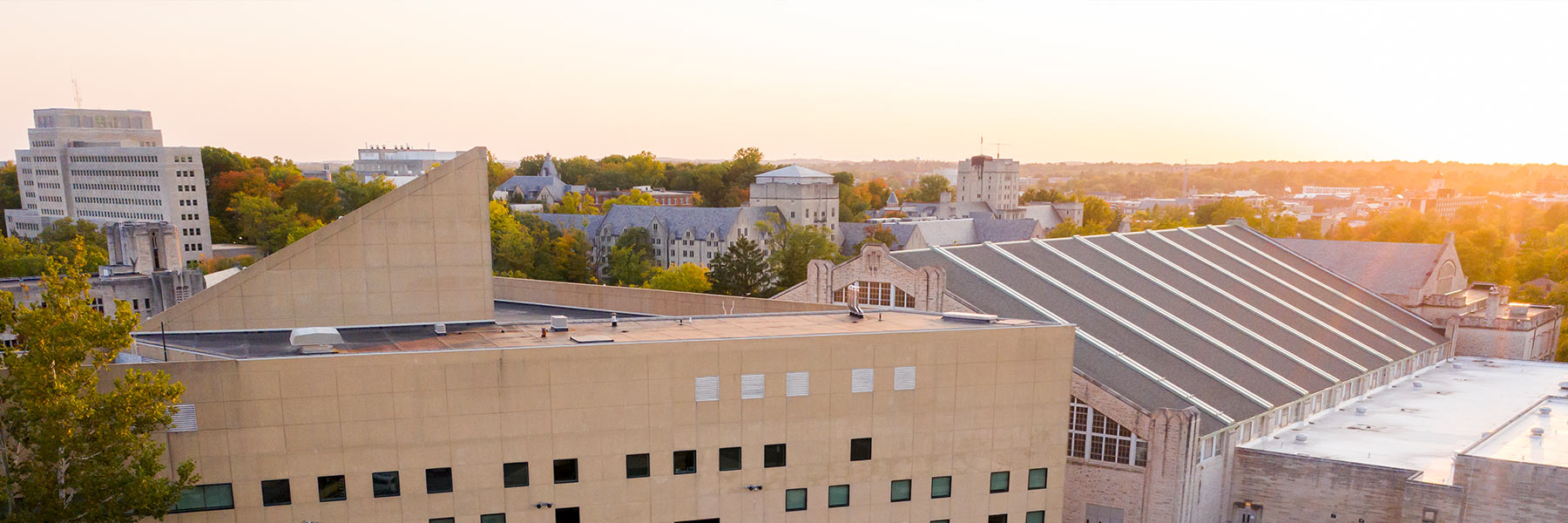 Drone view of the sun setting over the Eskenazi Art Museum and School of Public Health.